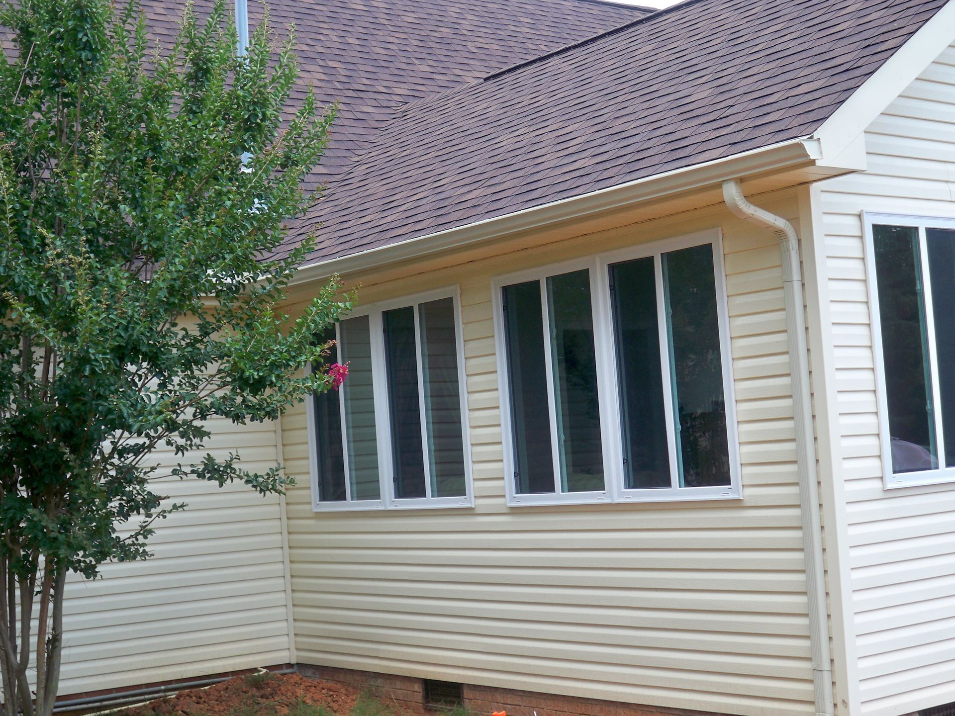 A house with a screened in porch and a purple roof.