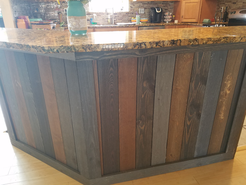 A kitchen with a wooden counter top and a granite counter top