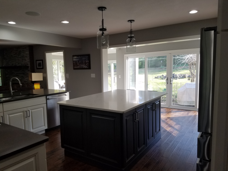 A kitchen with a large island and sliding glass doors