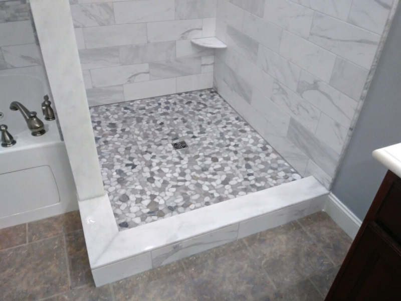 A bathroom with a walk in shower and a bathtub