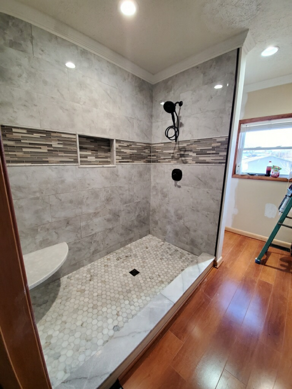 A bathroom with a walk in shower and a toilet.