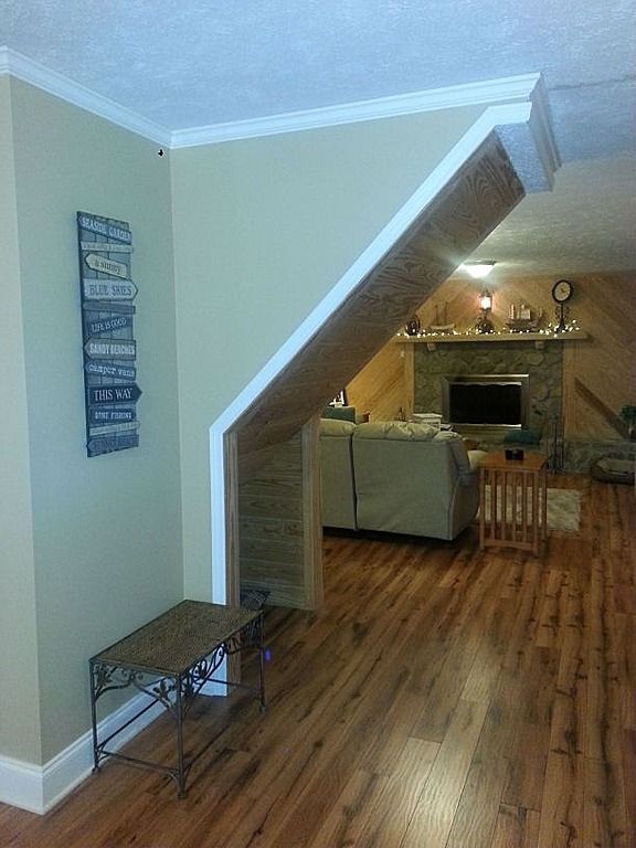 A living room with hardwood floors and a fireplace