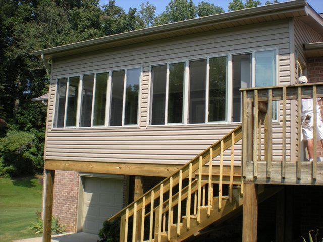 A house with a deck and stairs leading up to it