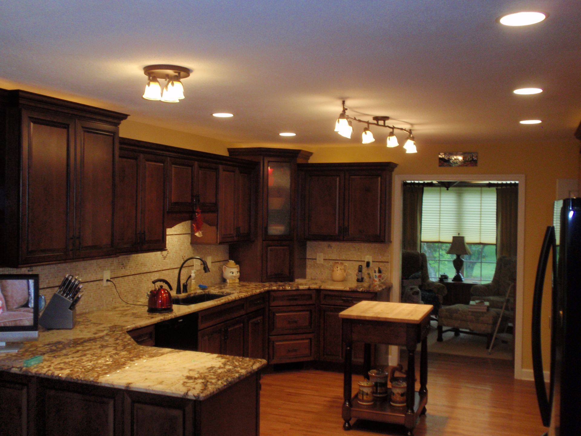 A kitchen with wooden cabinets and granite counter tops
