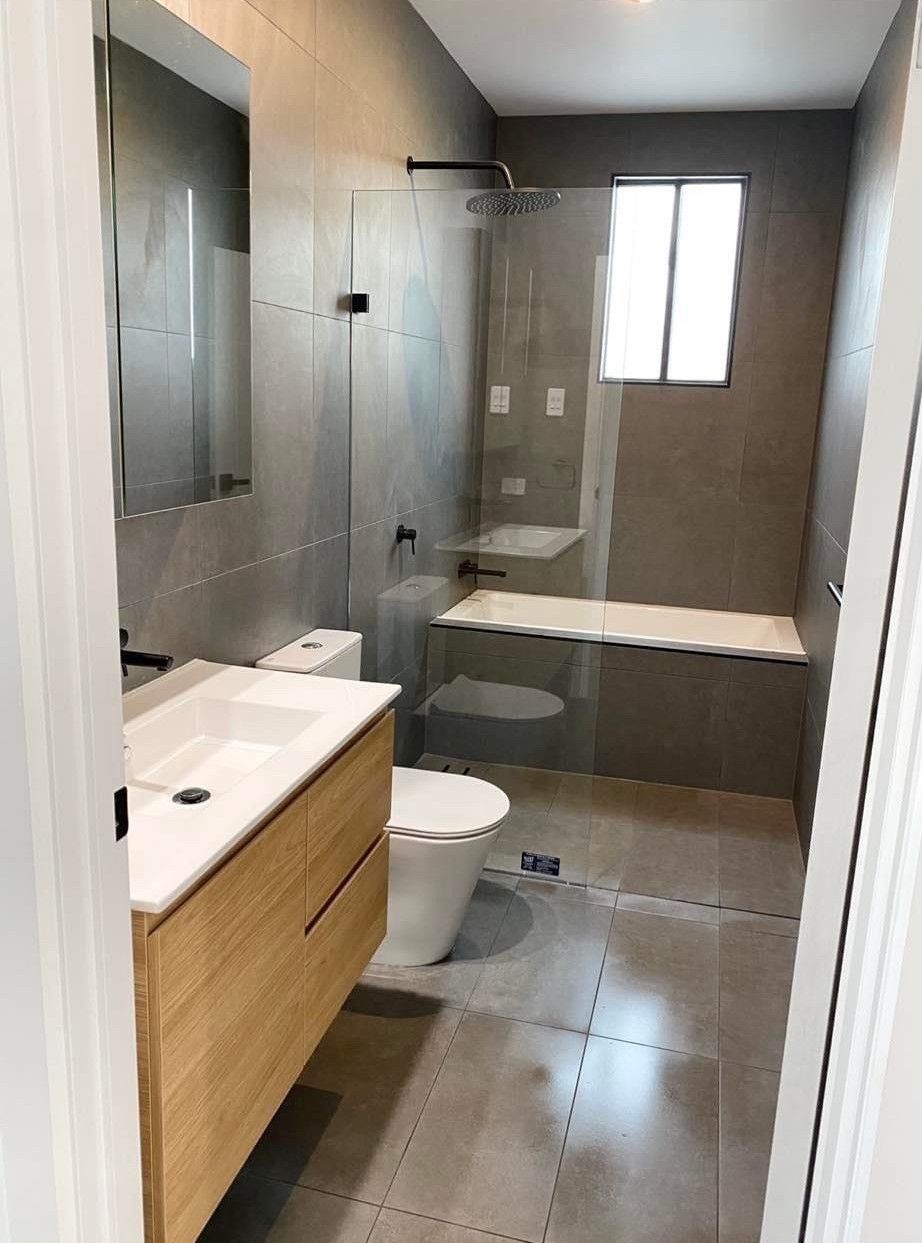 A Bathroom With a Toilet, Sink, and Shower — Subat Plumbing Services in Kurri Kurri, NSW