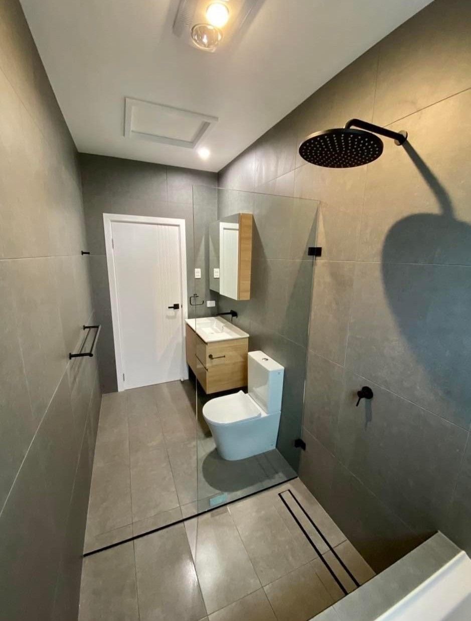 A Bathroom With a Toilet, Sink and Shower — Subat Plumbing Services in Kurri Kurri, NSW