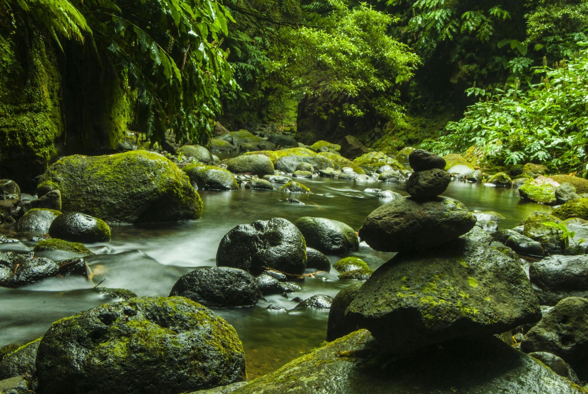 A river with rocks stacked on top of each other