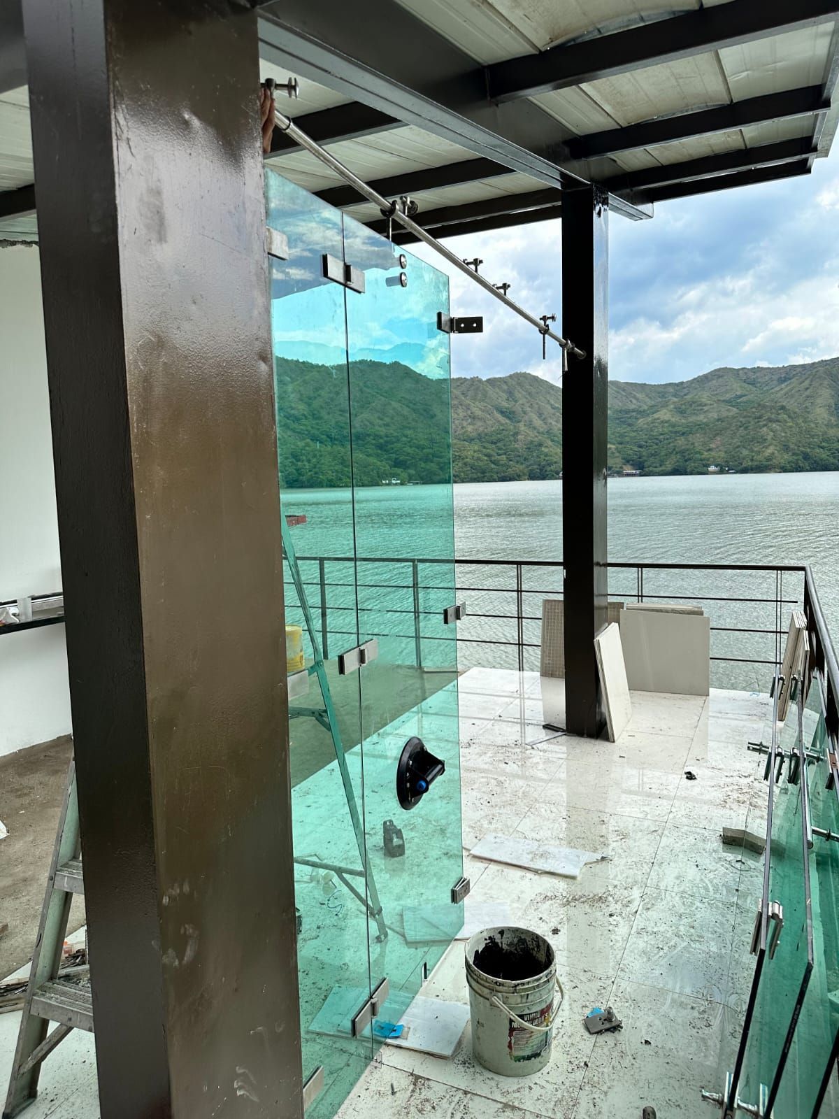 Paneles de vidrio instalados en una terraza con vistas a un lago y a las montañas