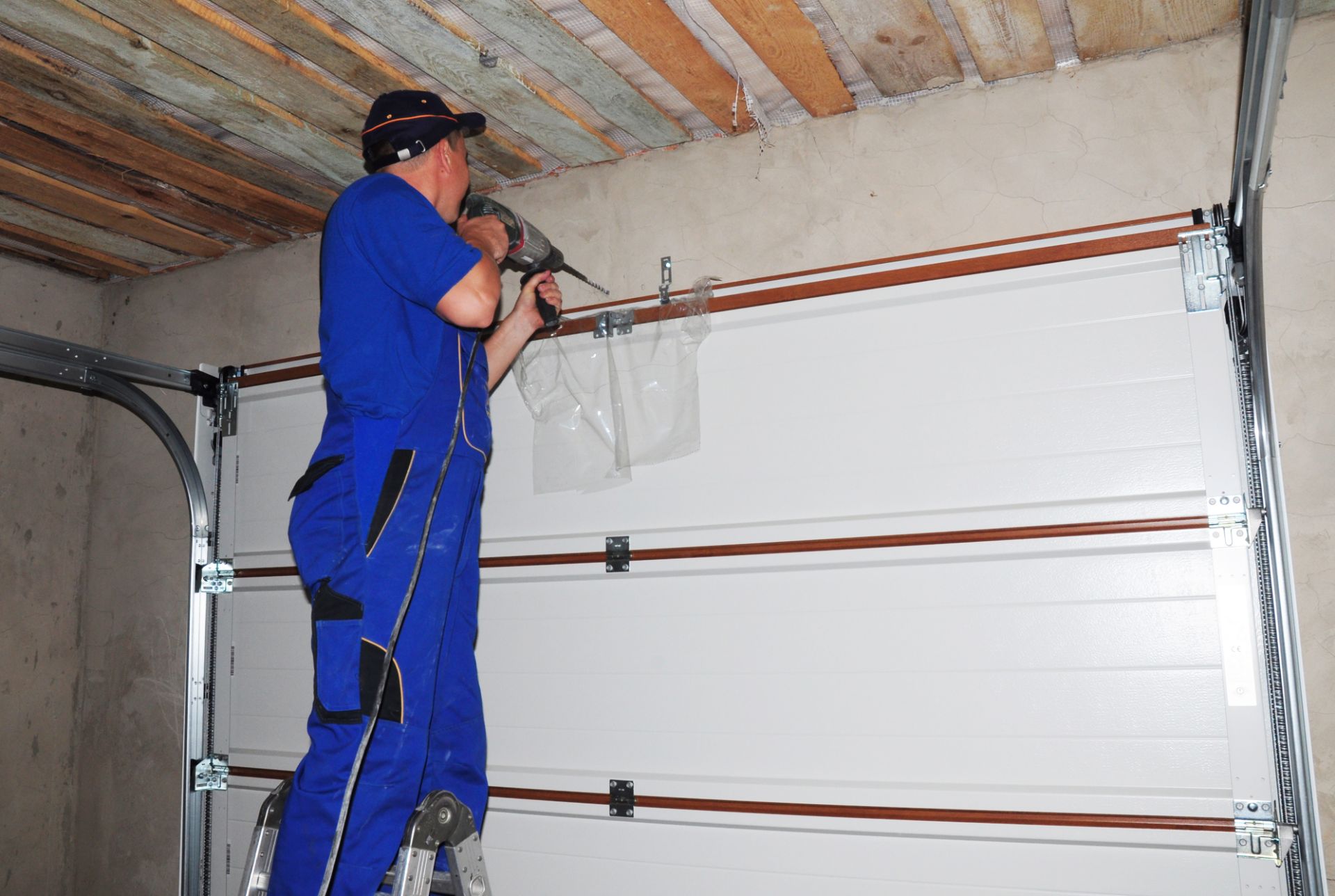 A worker installing a garage door