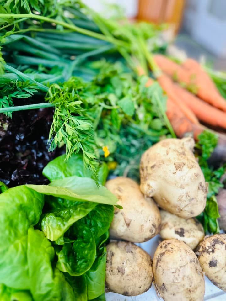 A bunch of vegetables are sitting on top of each other on a table.
