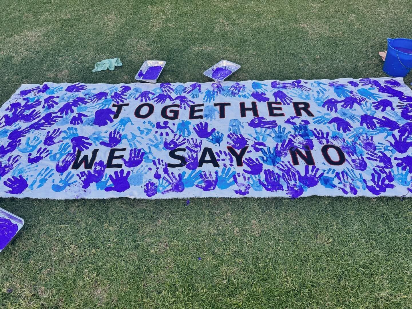 A blue and white sign that says together we say no