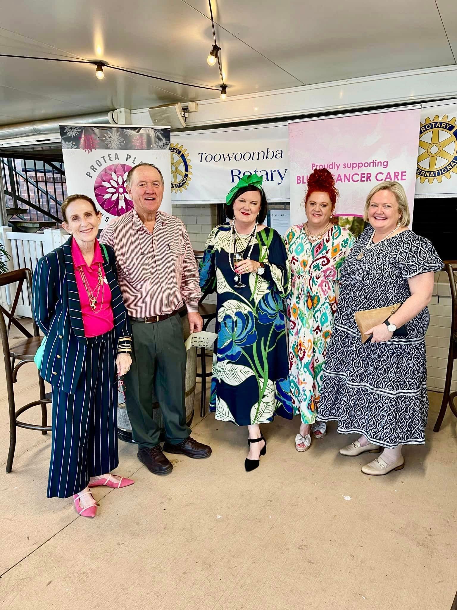 A group of people are posing for a picture in a room.