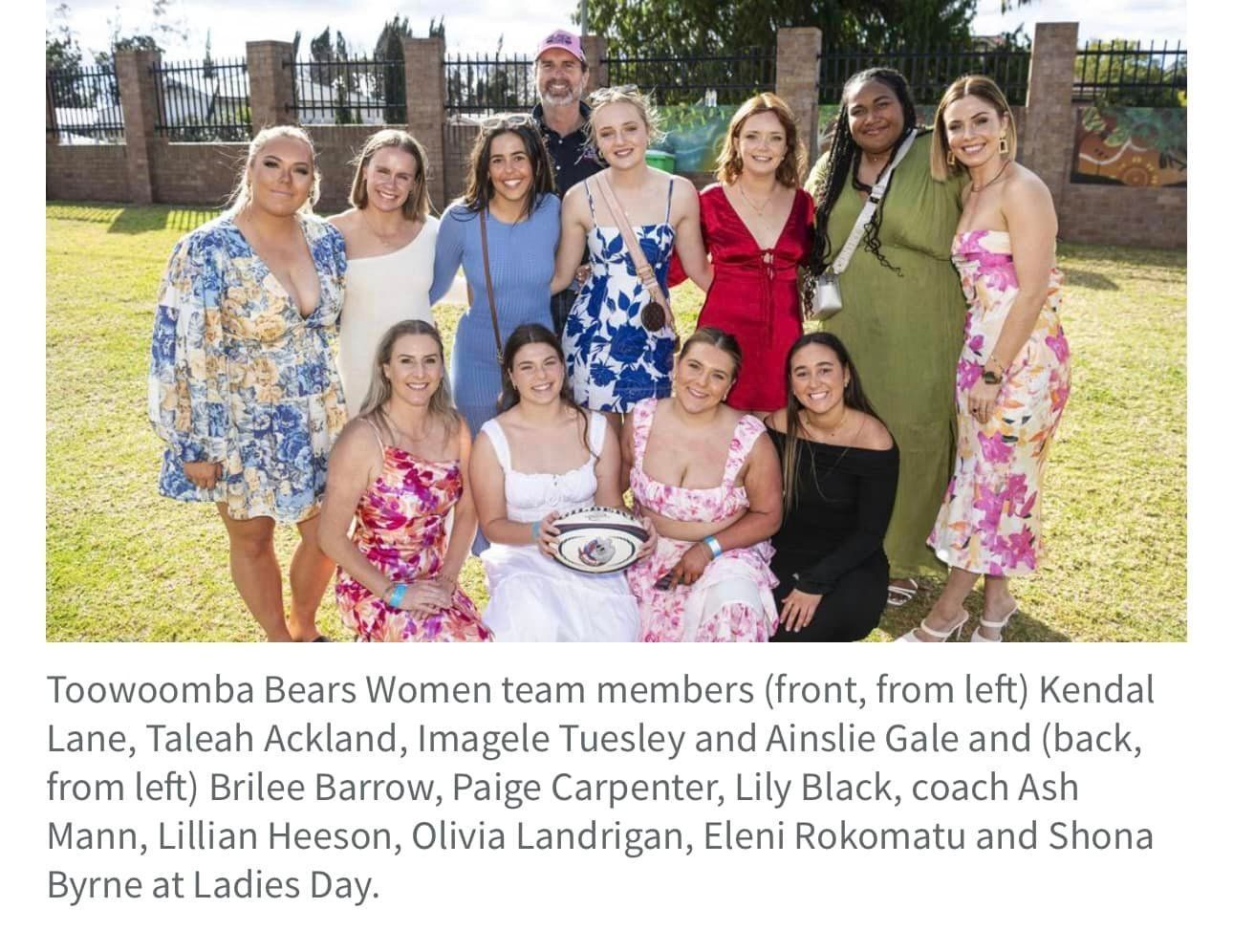 A group of women are posing for a picture together