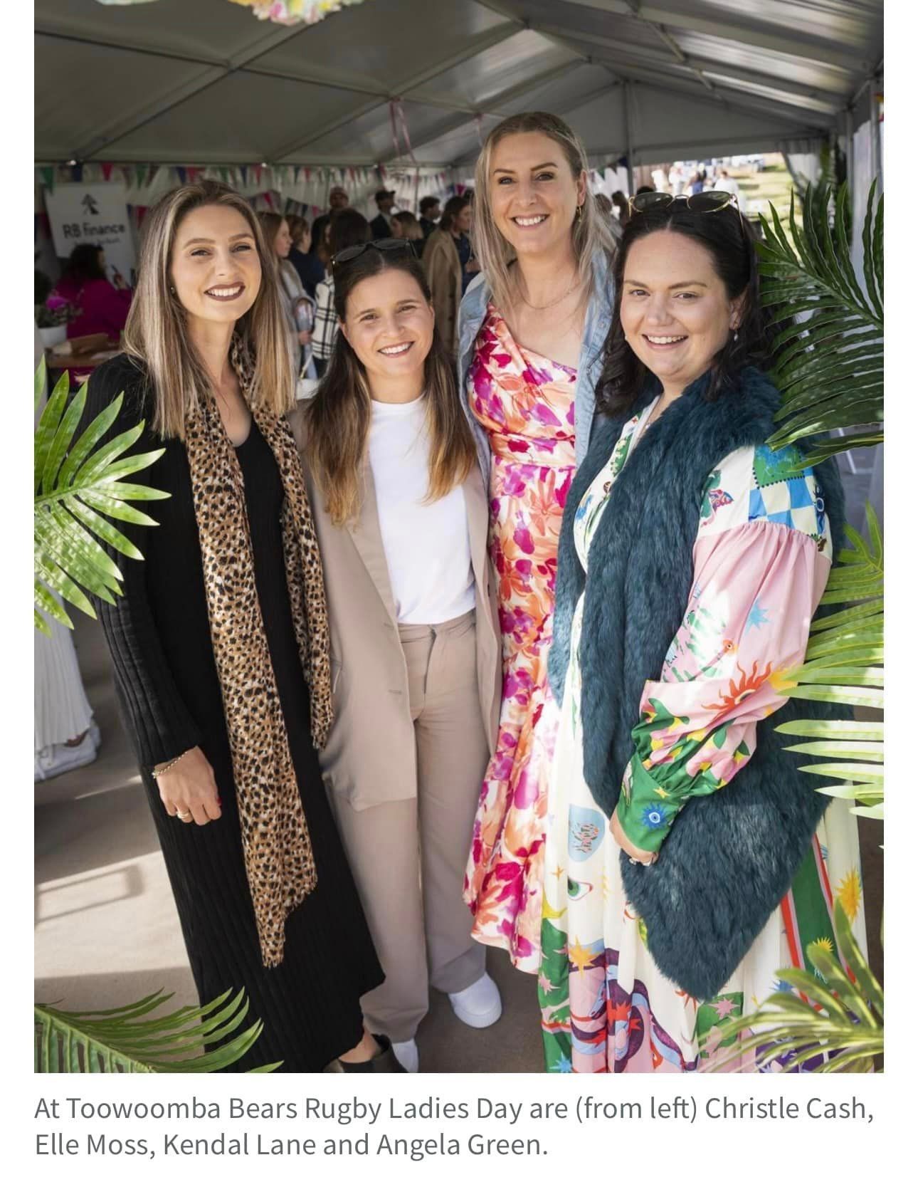 A group of women are posing for a picture in a tent.