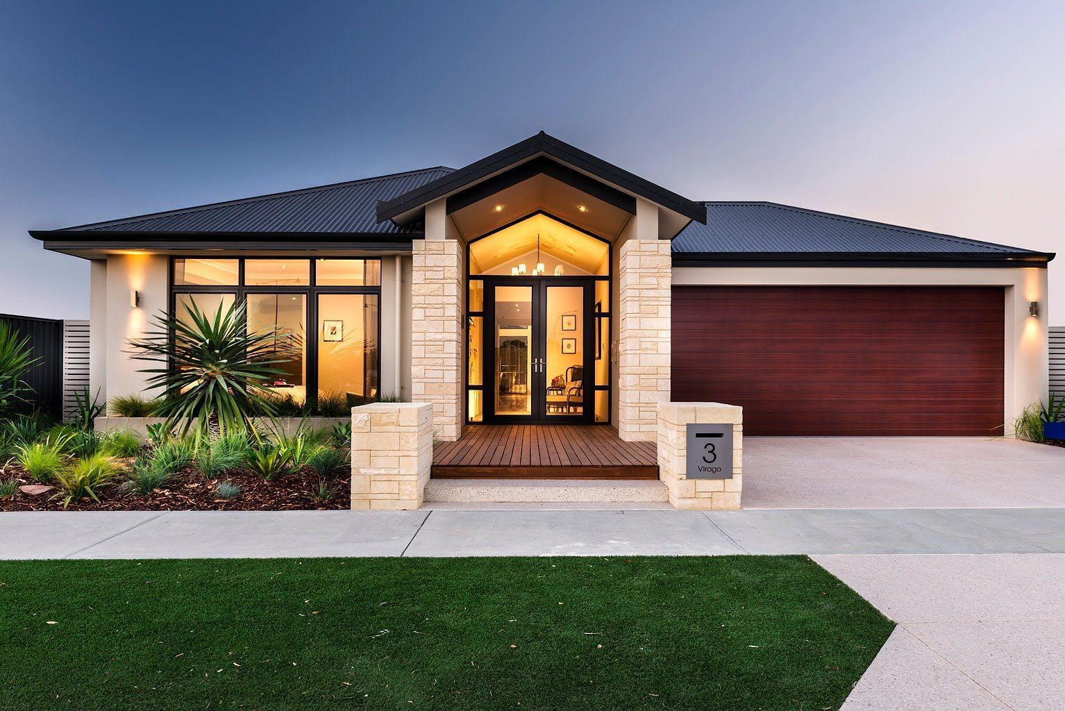 The front of a modern, stone-brick house with a brown garage door