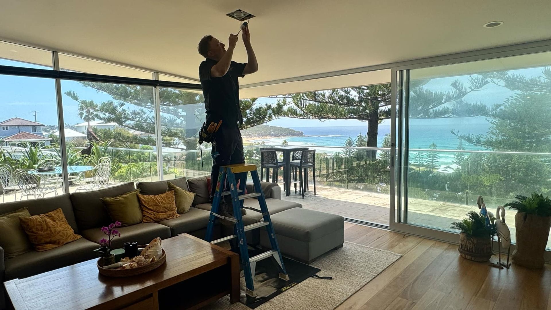 Man fixing light on ceiling