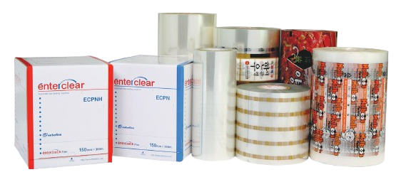 Various rolls of packaging film and branded boxes labeled