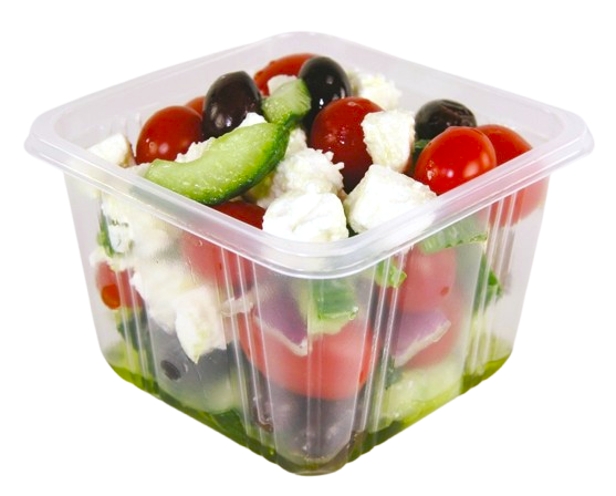 A clear, square plastic container filled with a Greek-style salad containing tomatoes, olives, cucumber, and feta cheese.