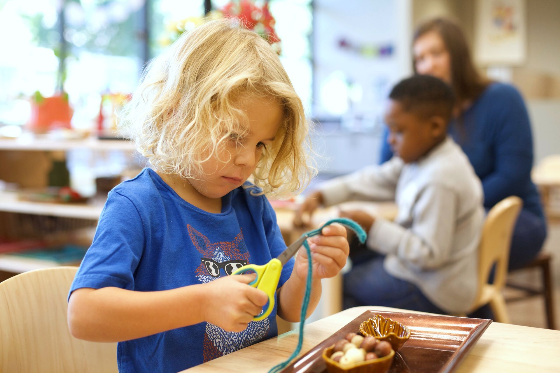 Montessori  children and guide in the classroom