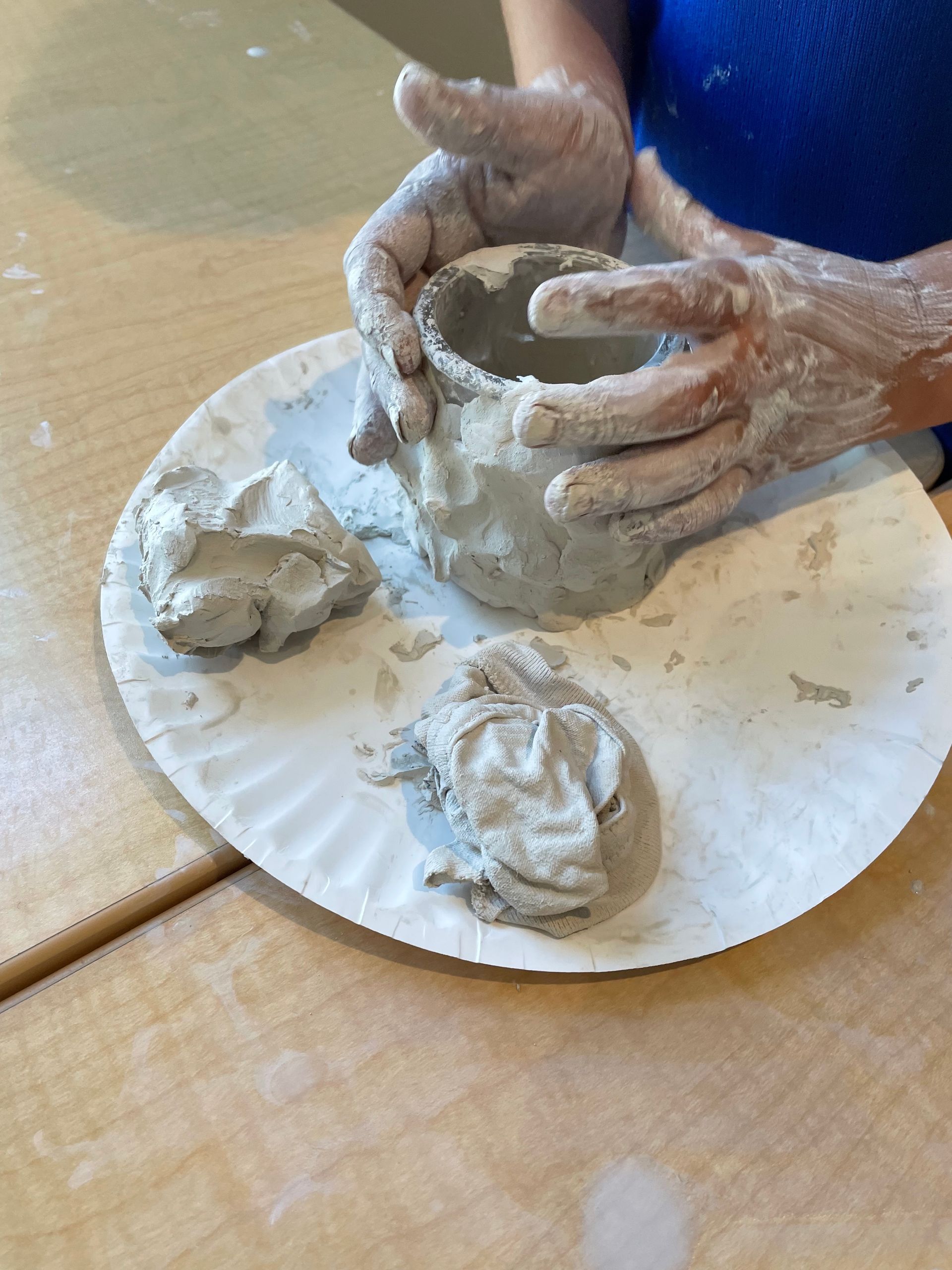 Child sculpting with clay in the summer program