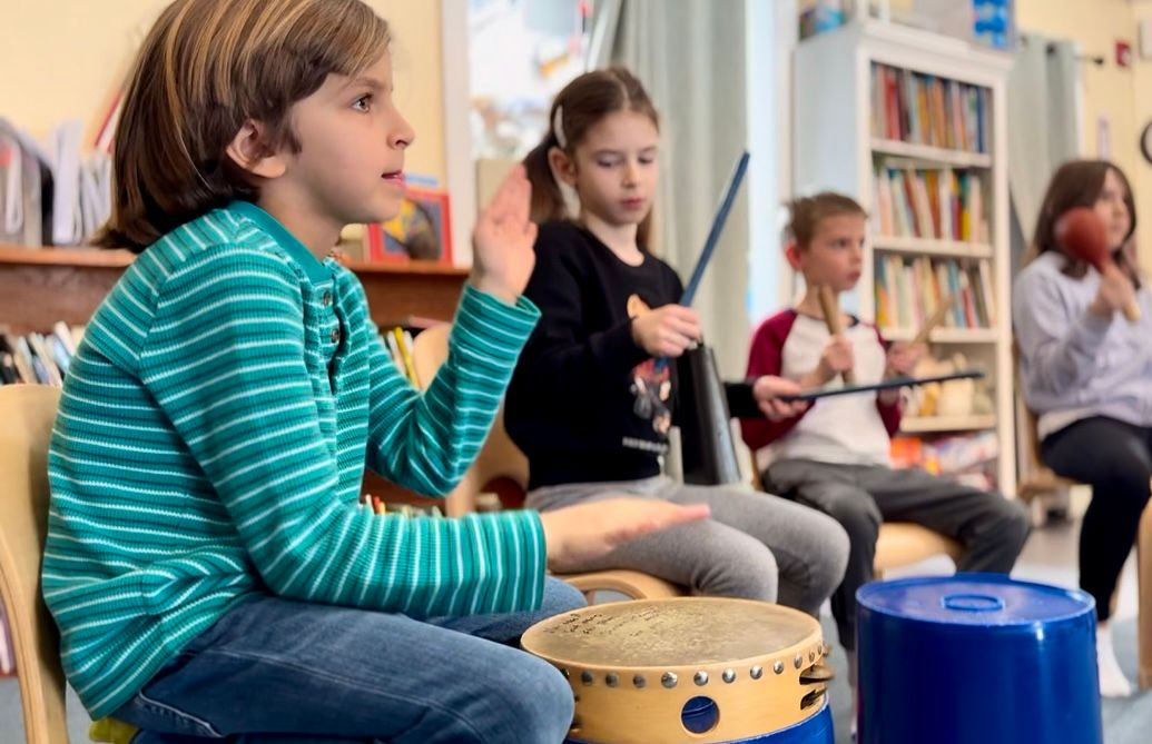Montessori students drumming 