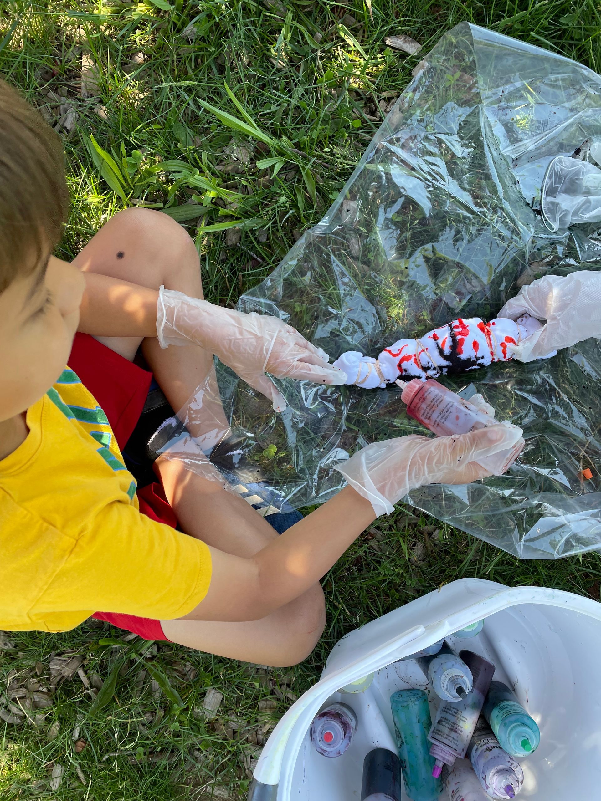Child tie-dying a T-shirt in the summer program
