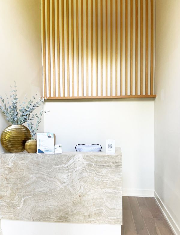 a reception desk in a room with a wood wall