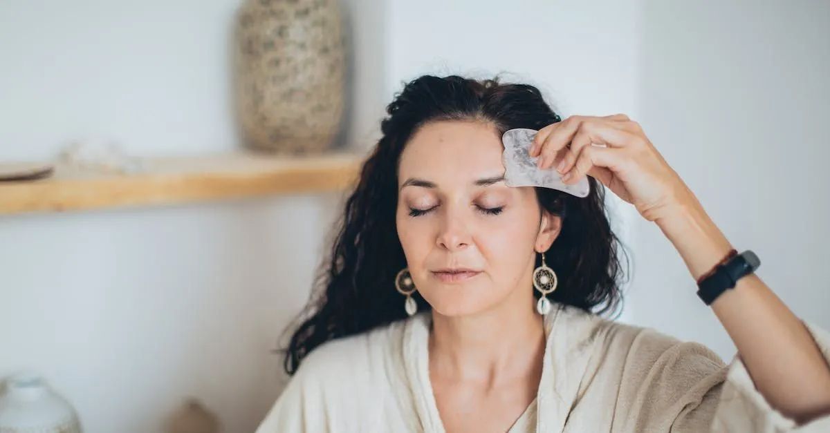 a woman is holding a piece of paper to her forehead