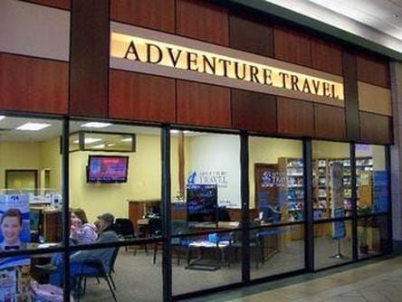 Adventure Travel Office front A building with a sign that says adventure travel