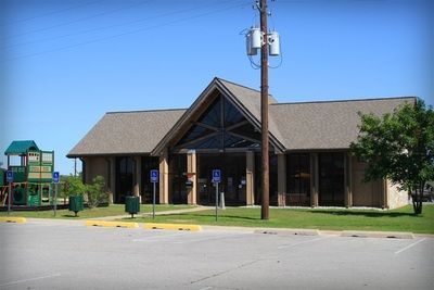 A small building with a playground in front of it