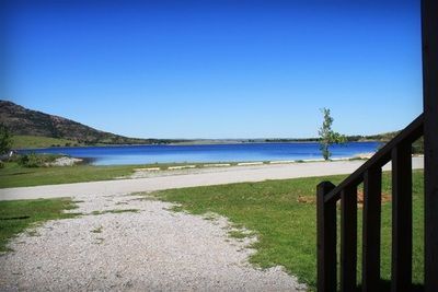 A view of a lake from a balcony on a sunny day