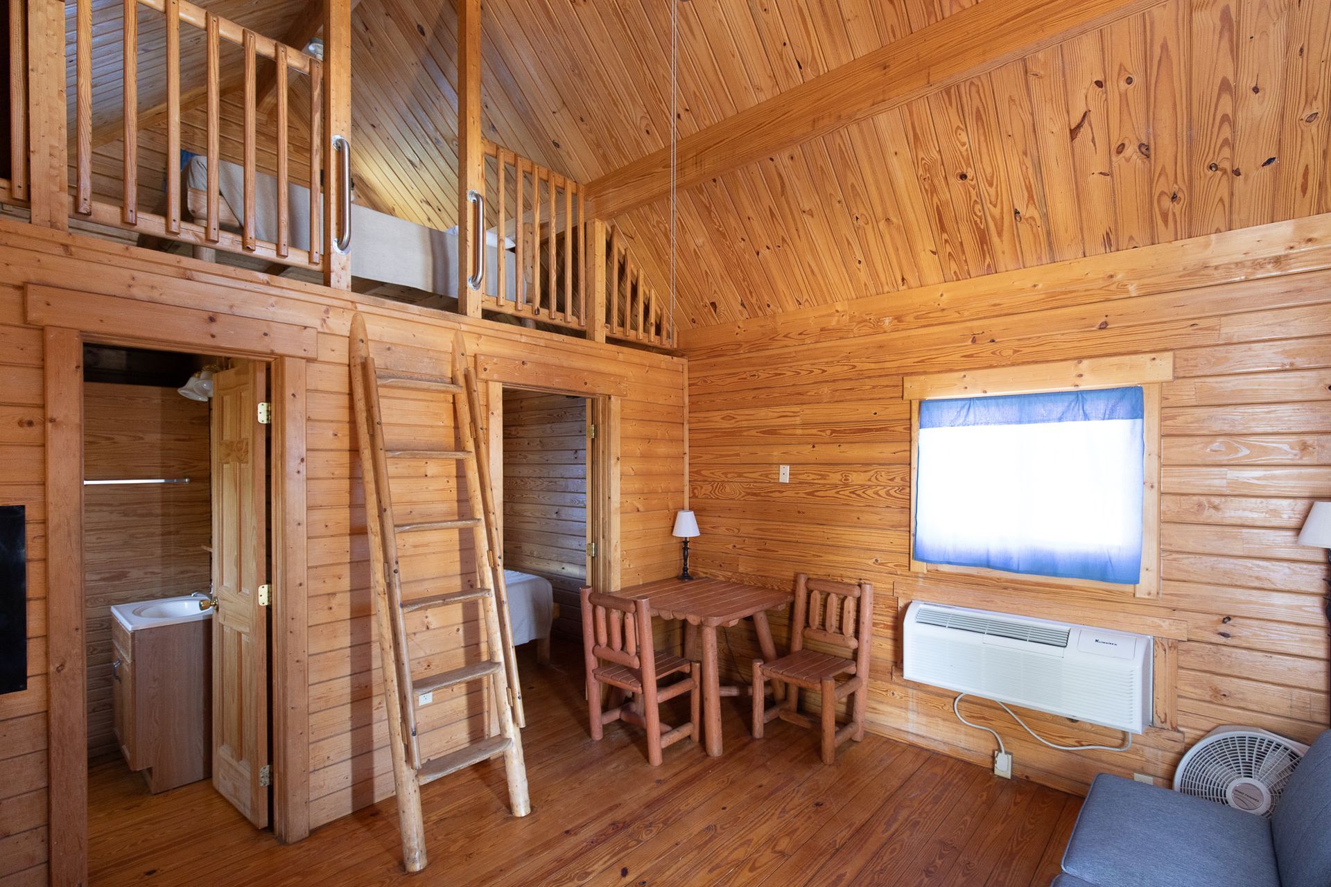 interior of log cabin Interior view of eating and sleeping area in log cabin