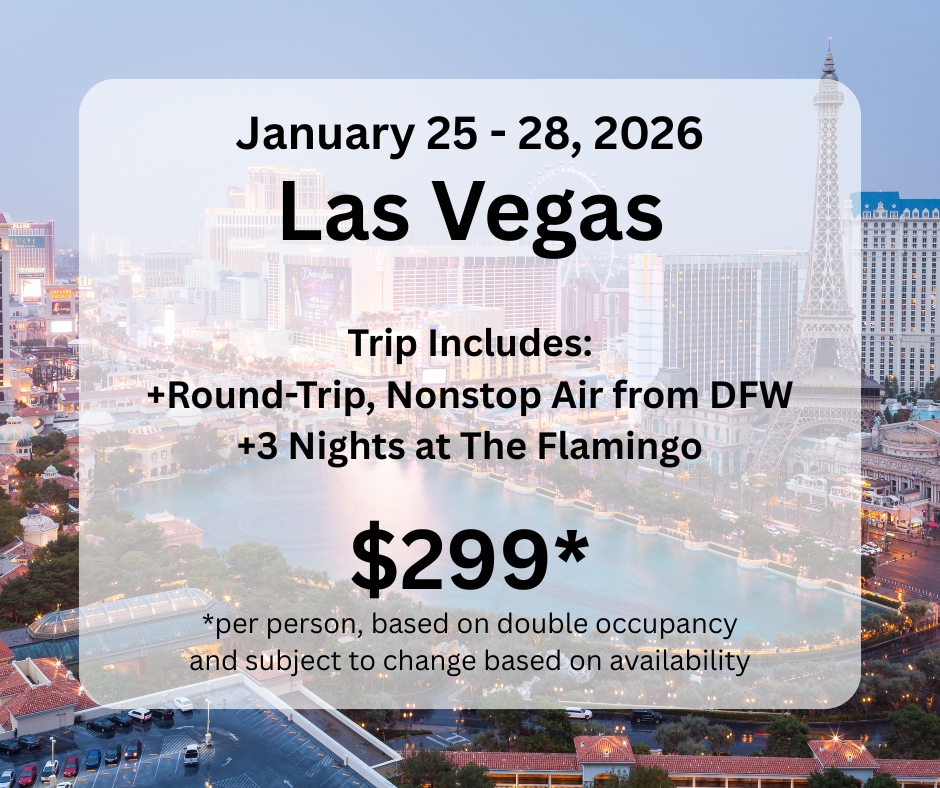 giraffes infront of buildings A group of giraffes are standing in front of a large building.