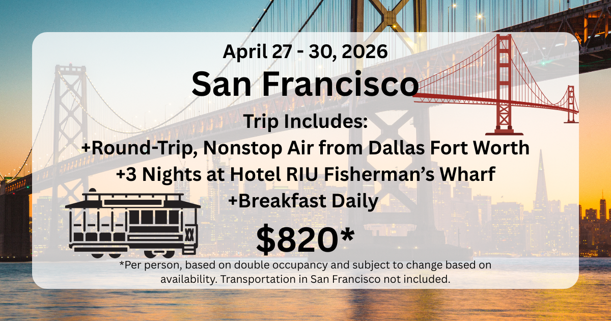 A group of giraffes are standing in front of a large building.