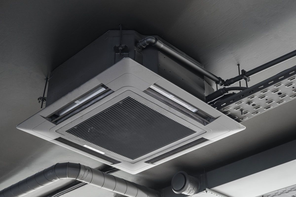 A close up of a ceiling mounted air conditioner.