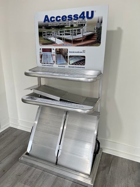 A display of aluminum ramps is sitting on a wooden floor in a room.