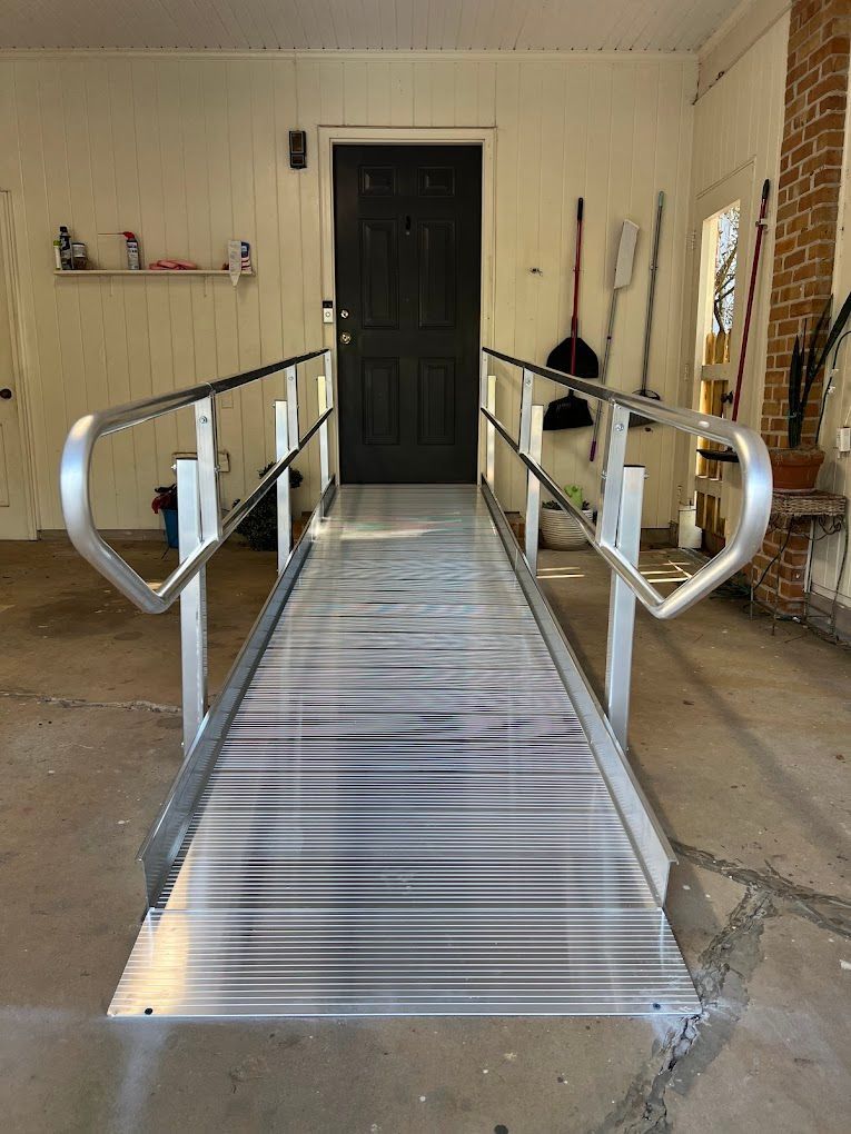 A ramp is leading to a door in a garage.