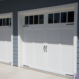 Michigan Wildlife Solutions - Two white garage doors on a blue house