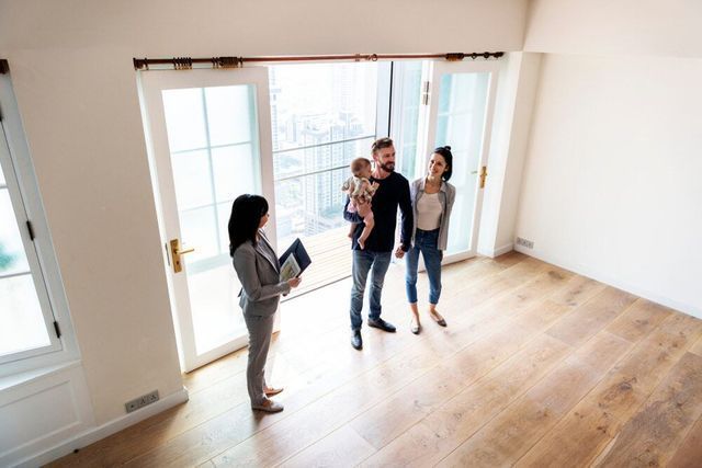 A Real Estate Agent Shows a Family — Richardson Conveyancing In Tumbi Umbi, NSW