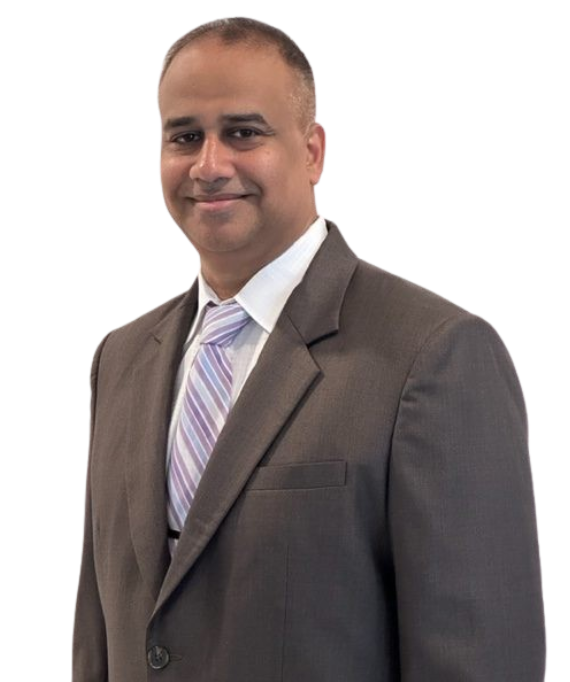 Man in a suit and tie smiling at the camera.