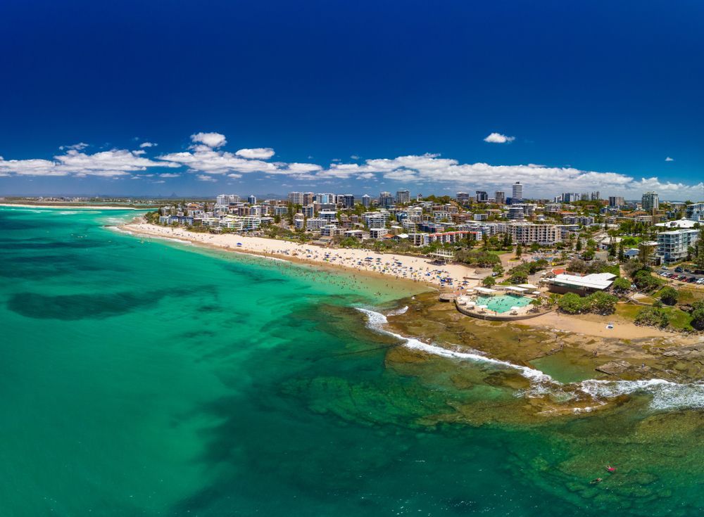 An Aerial View Of A Beach With A City In The Background — Suncoast Termite & Pest In Caloundra, QLD