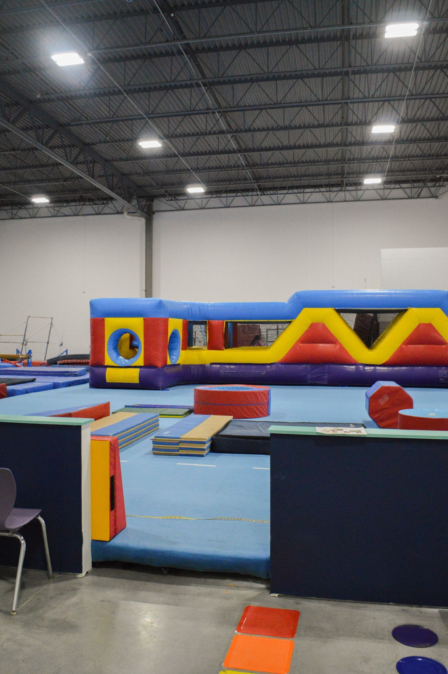 There is a large bouncy house in the middle of the gym.