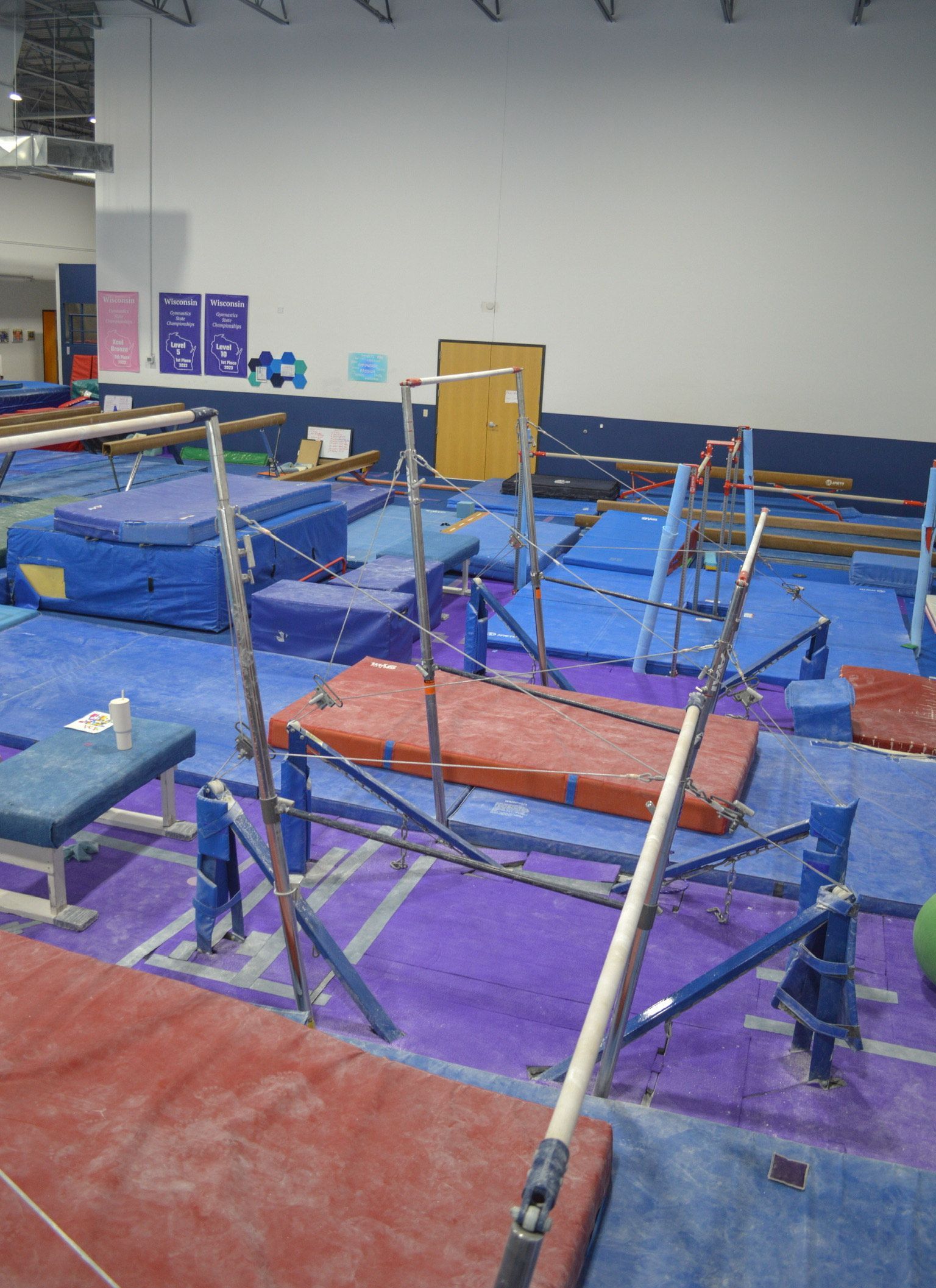 A gym filled with a lot of gymnastics equipment