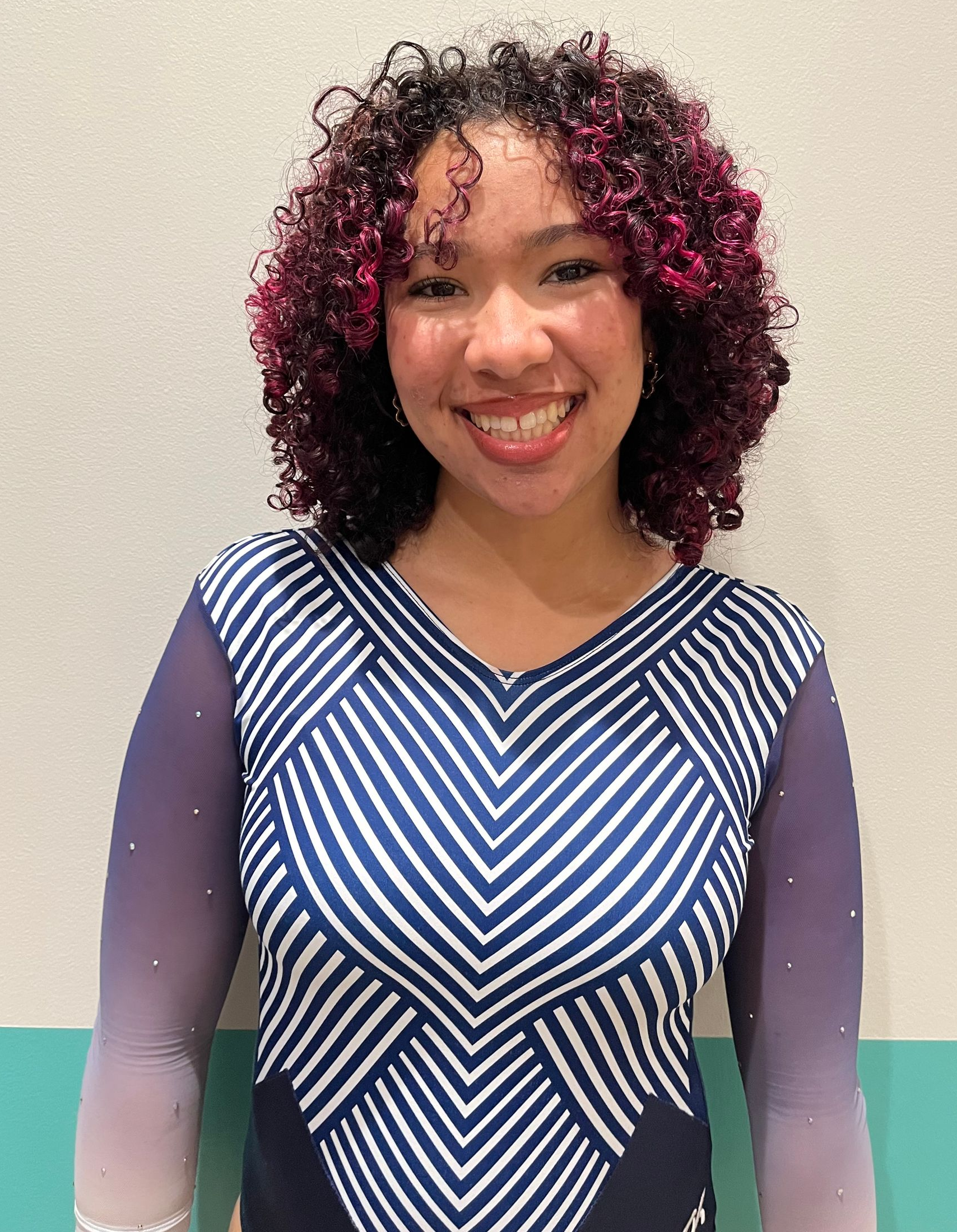 A man is sitting on a ferris wheel and smiling.