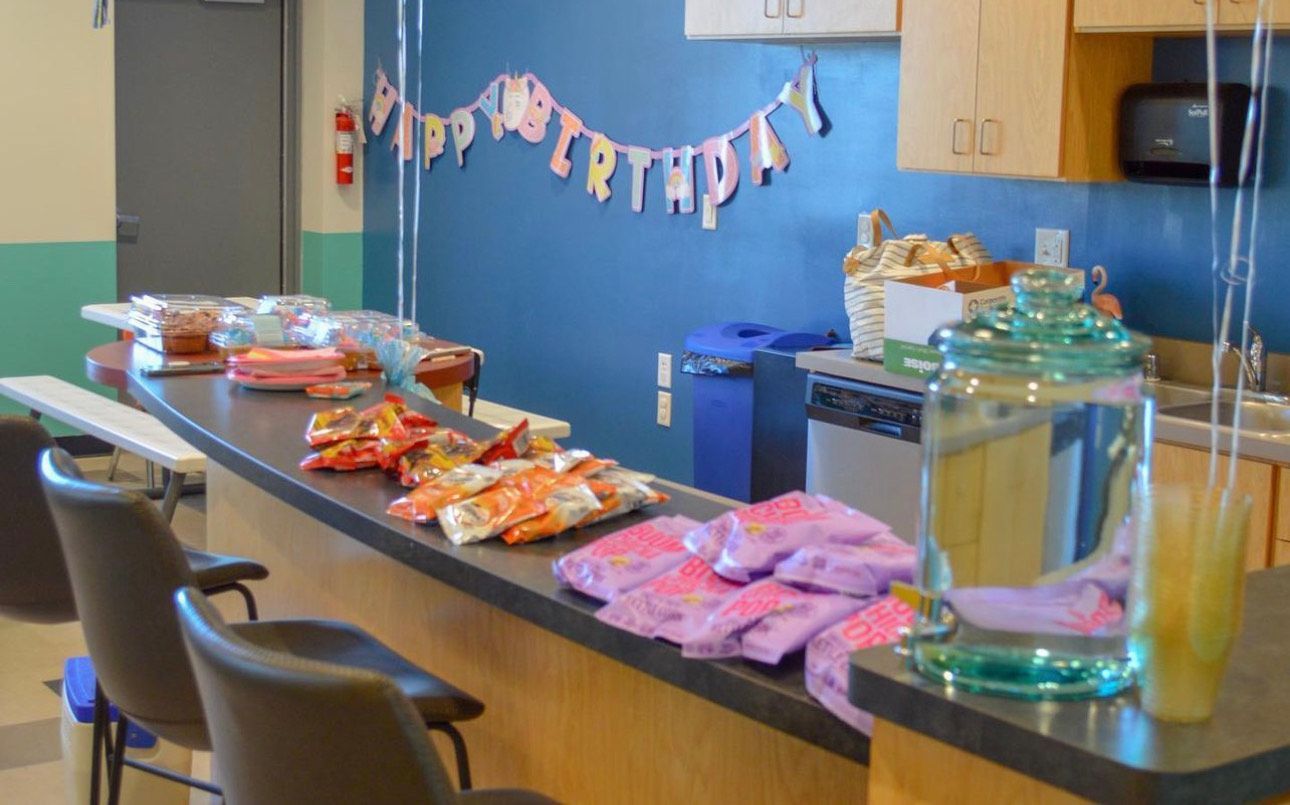 A kitchen with a happy birthday banner on the wall