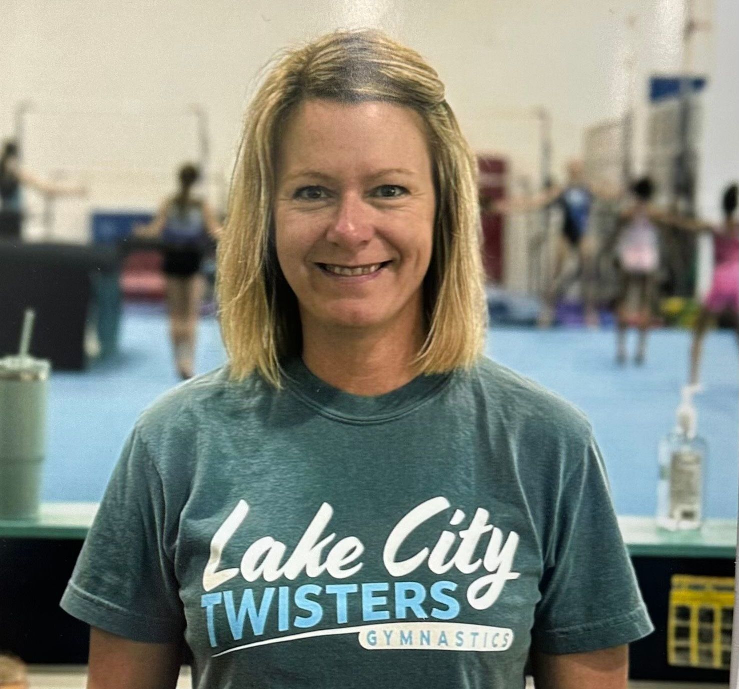 A woman wearing a lake city twisters t-shirt smiles for the camera