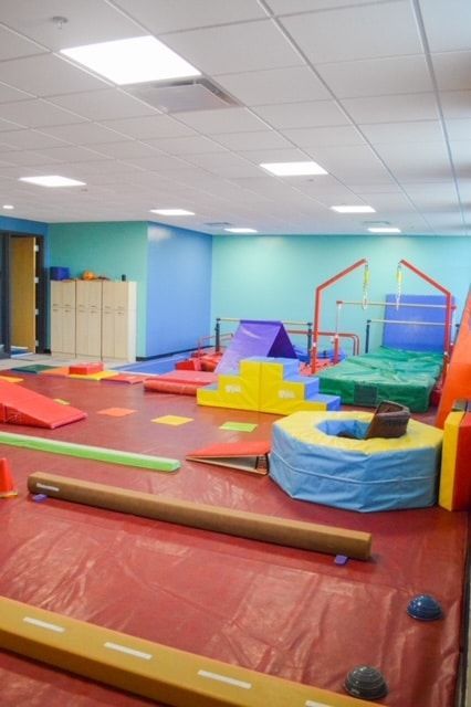 A gym filled with colorful toys and a balance beam