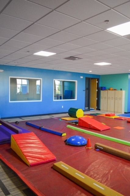 A gym with a lot of colorful toys on the floor