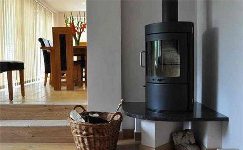 Wood burning and multi-fuel stove in corner