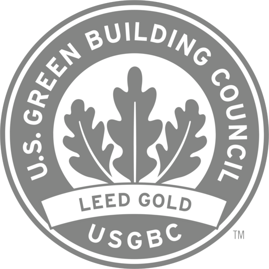A circular U.S. Green Building Council LEED Gold certification logo with three stylized oak leaves in the center.